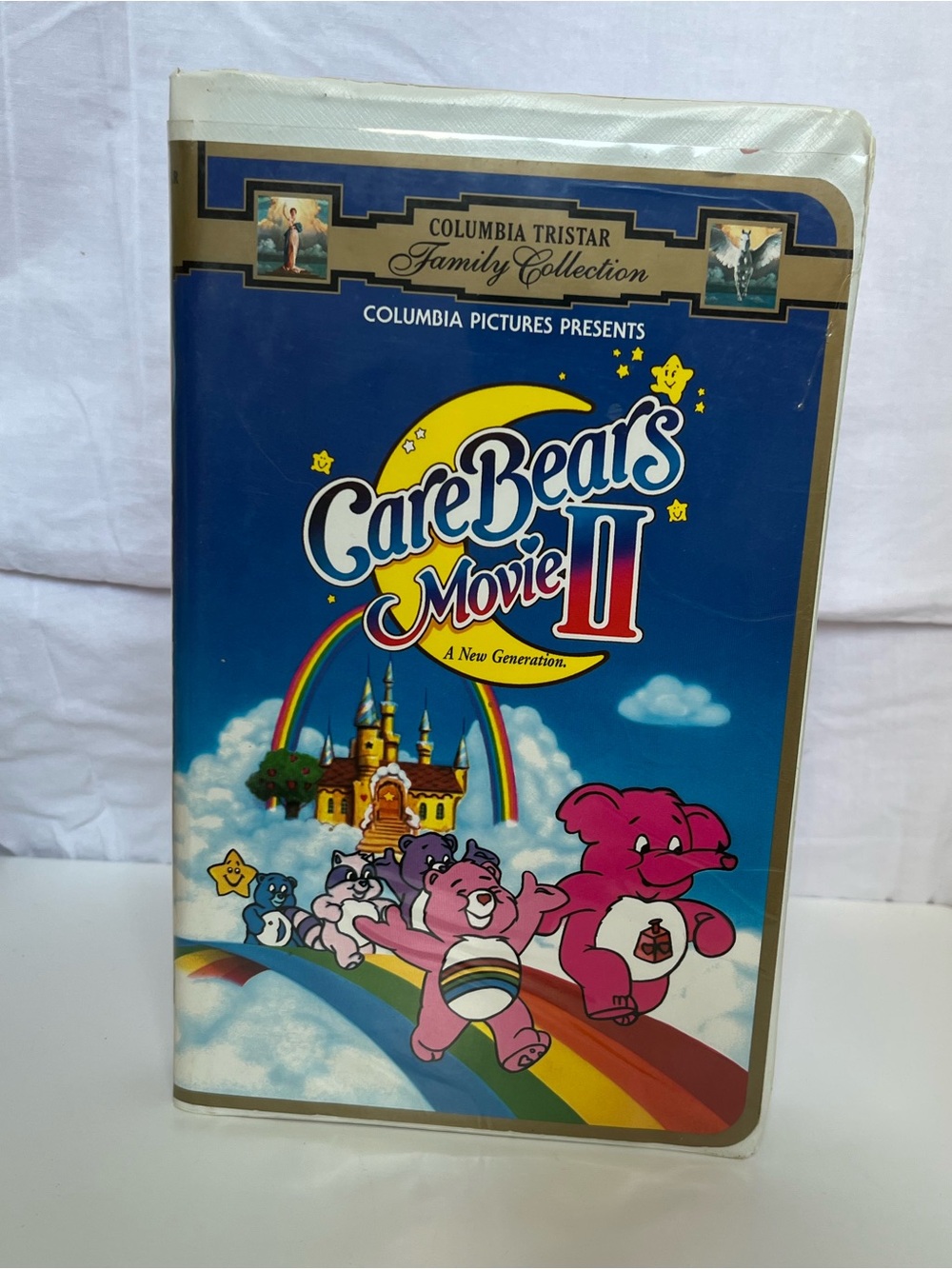 Vintage Care Bears Movie II Blue VHS Cover with Rainbow Characters